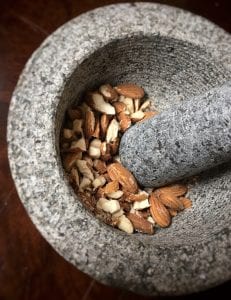 Mortar and Pestle Smashing Almonds